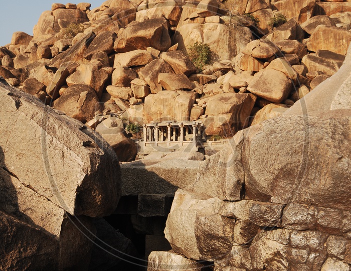 a temple in an open area with large rocks around