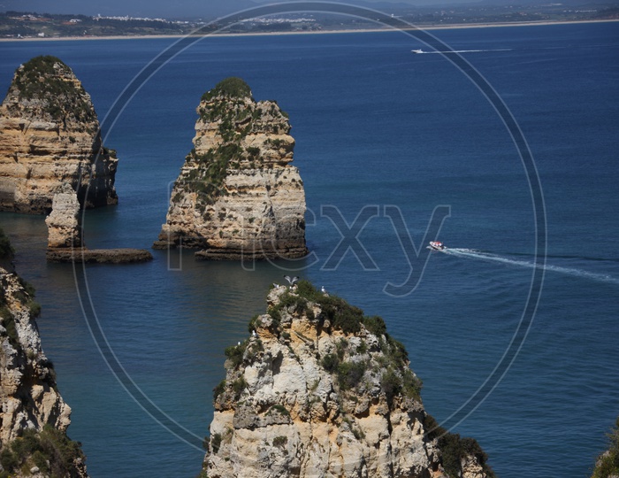 a speed boat moving on the sea at ponta da piedade