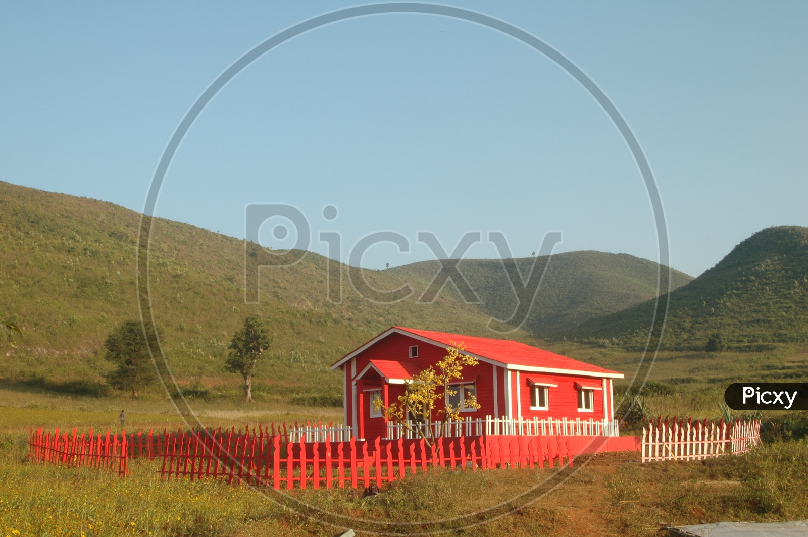 A red colored farm house in the fields of Araku valley