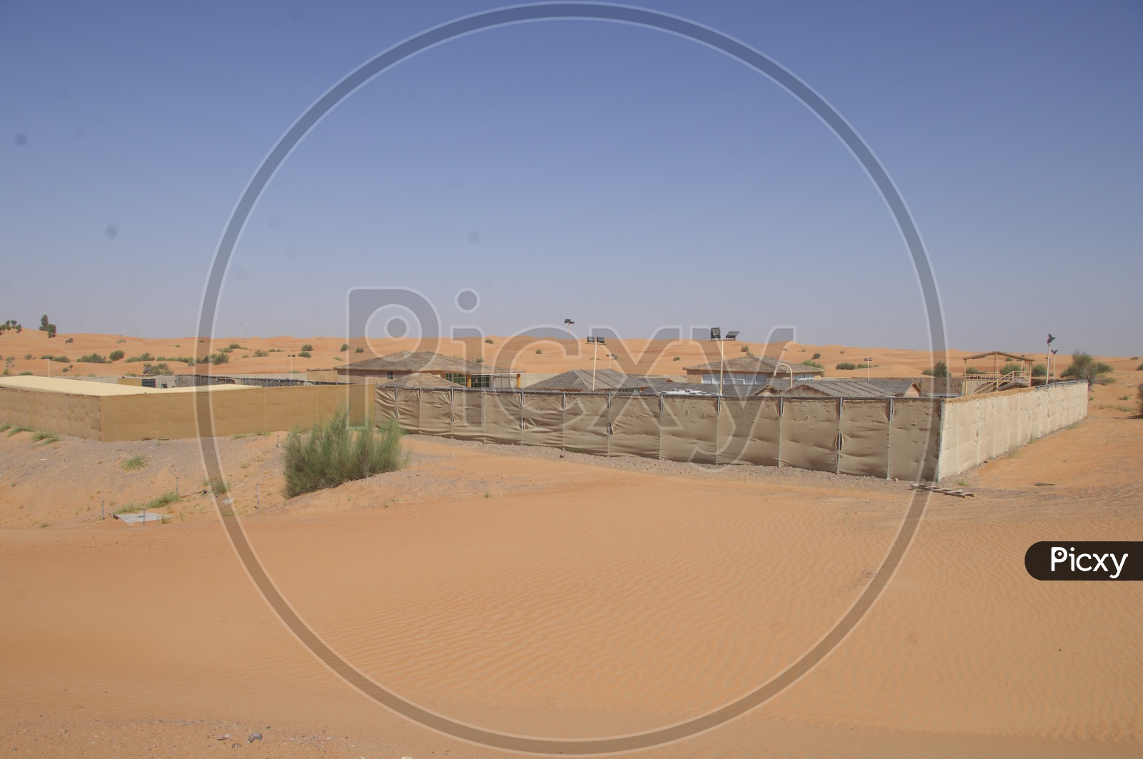 A Camp Area With Huts In Desert
