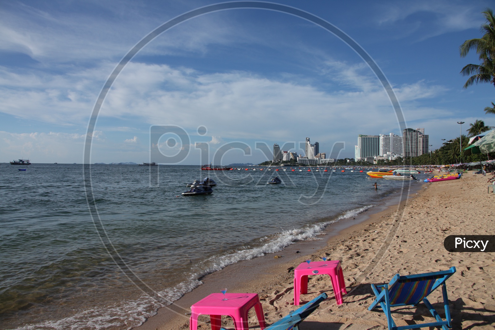 Beach view with boats and chairs around