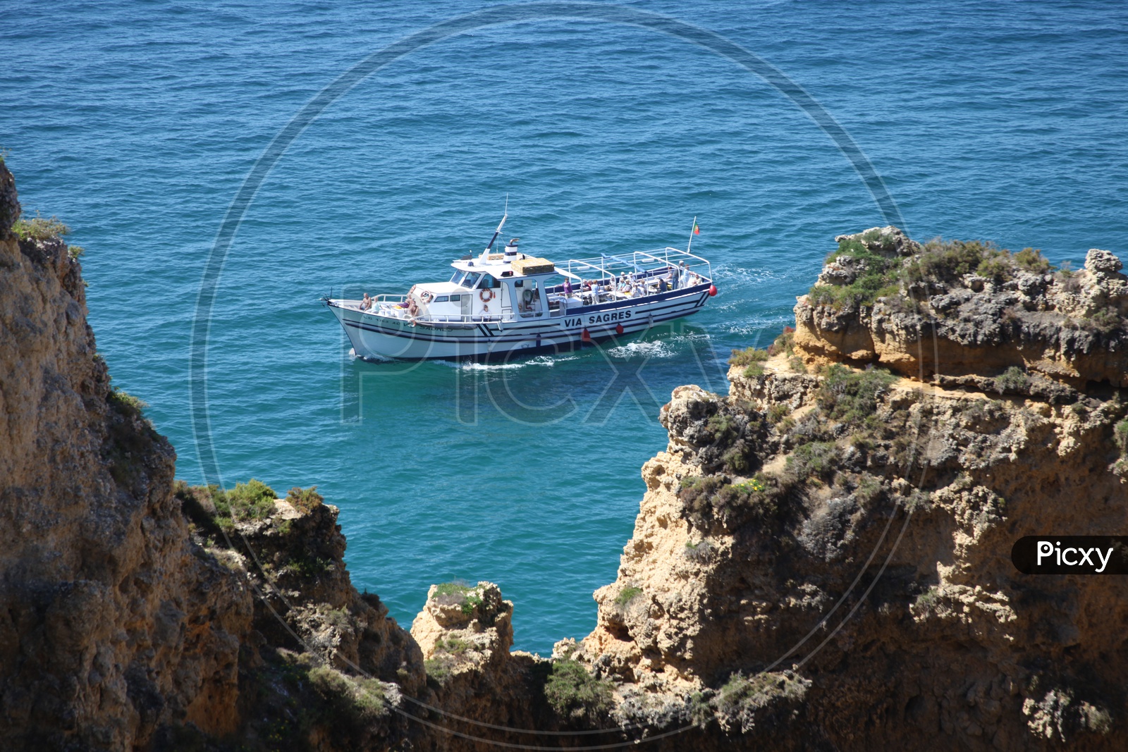 view from the cliff of a boat moving on the sea