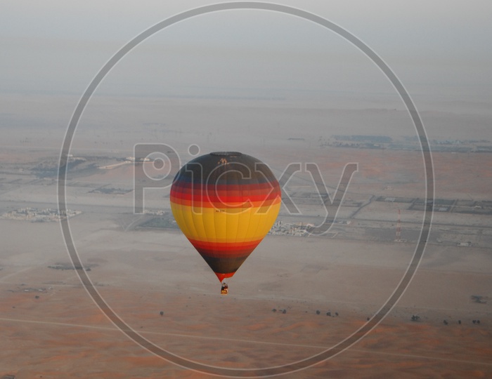 Colorful Hot Air Balloon Flying Over Dubai Desert