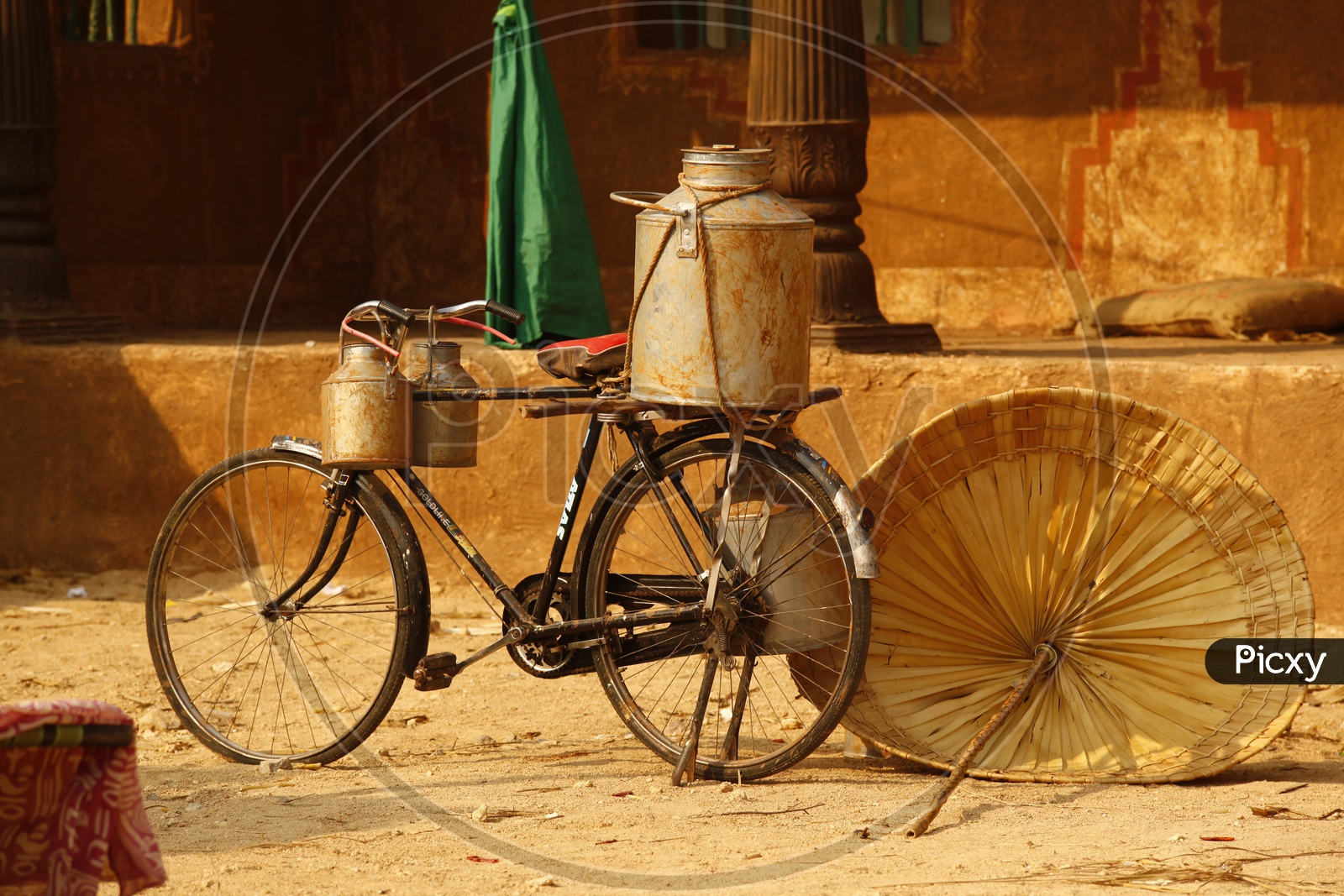 Milk Cans Tied on  Bicycle in Village