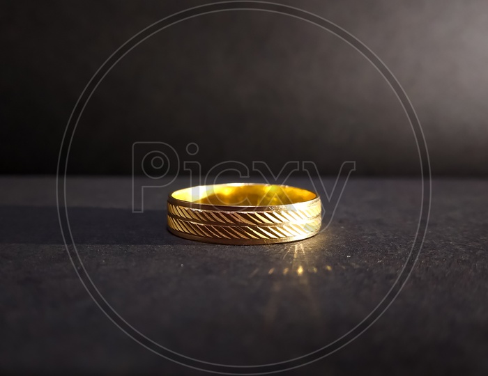Gold finger ring with black background