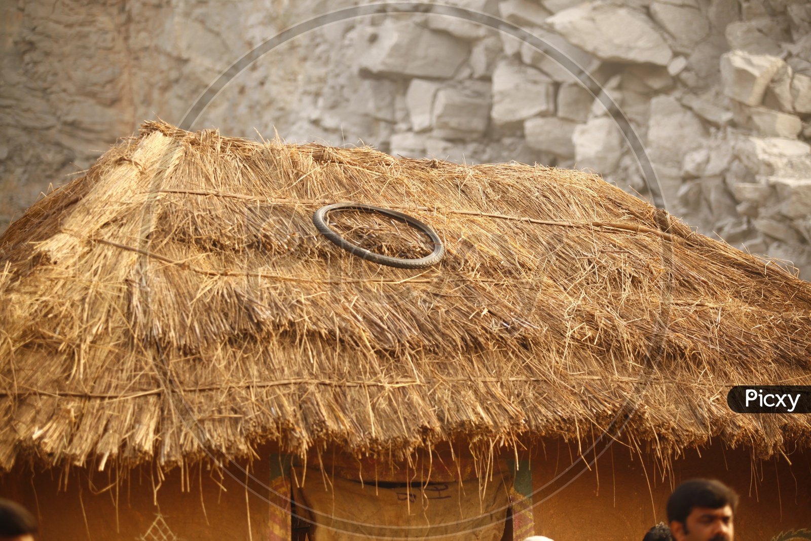 A tyre on a thatched roof