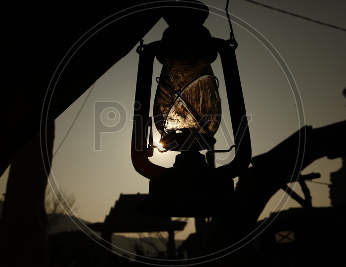 Silhouette of Kerosene Lantern Hanging in Rural Village