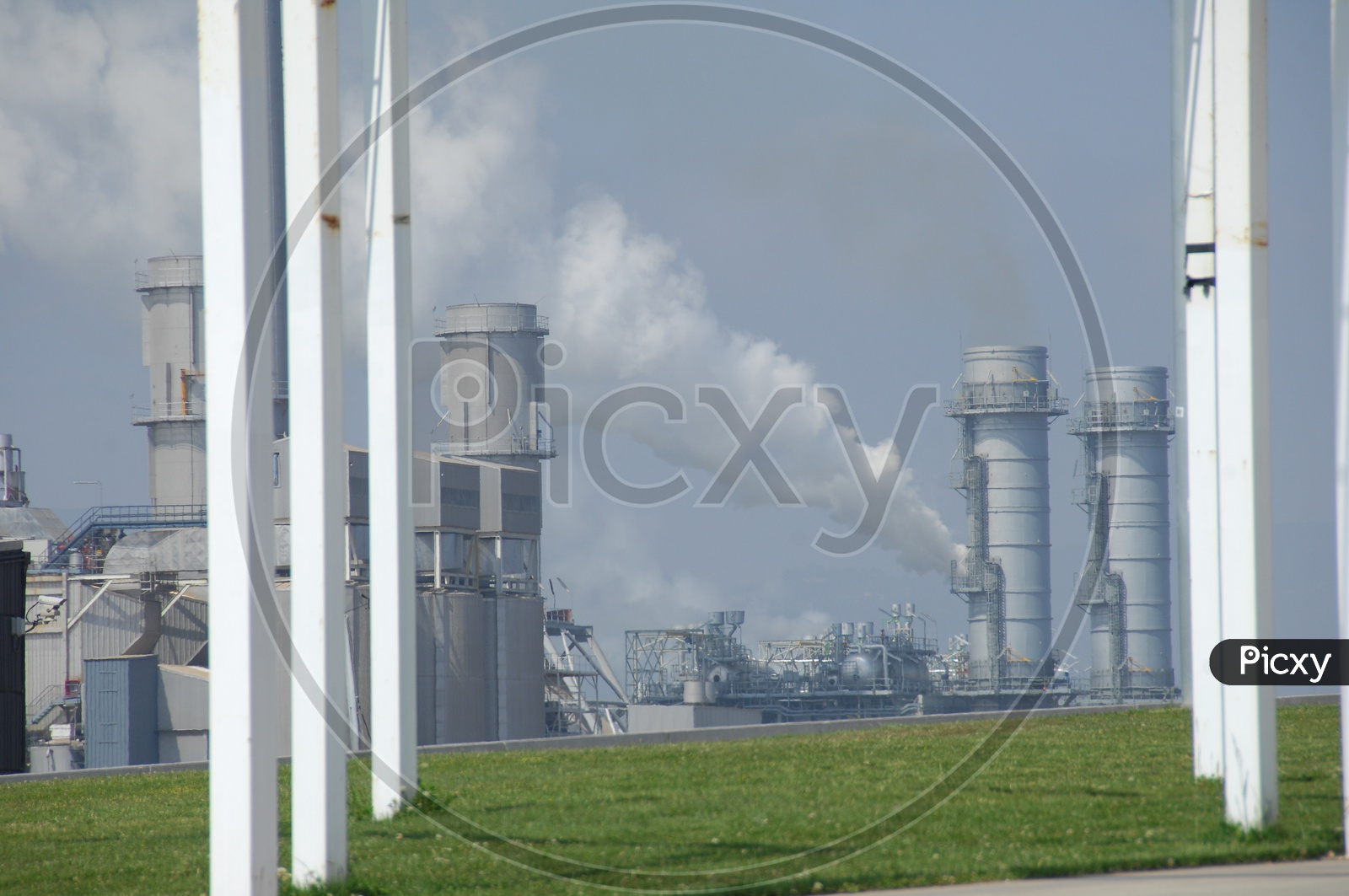 Industries With Exhaust Towers And Thick Smoke Coming Out From Pipes