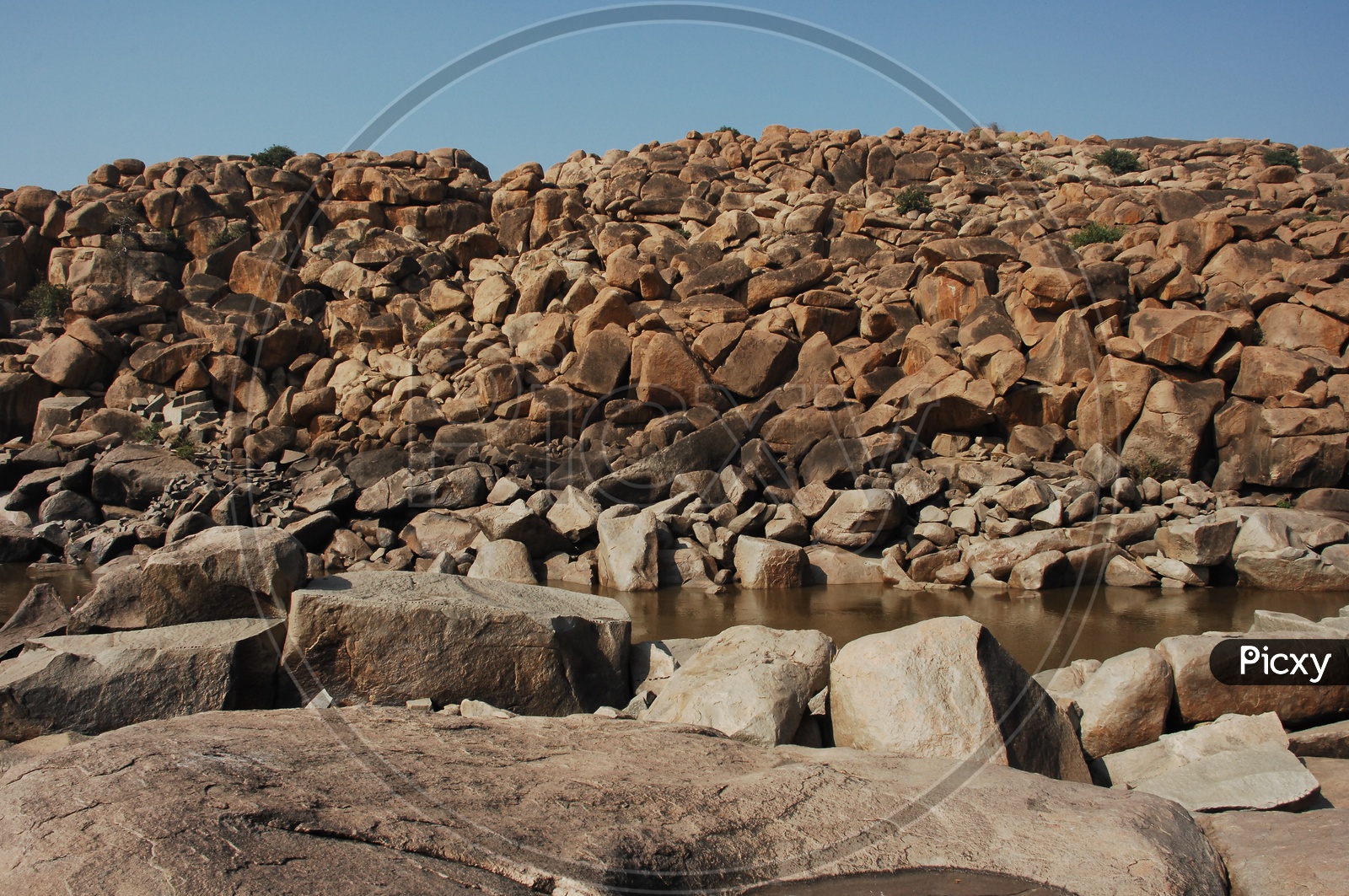 large rocks in an open area and water
