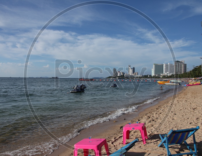 Beach view with boats and chairs around