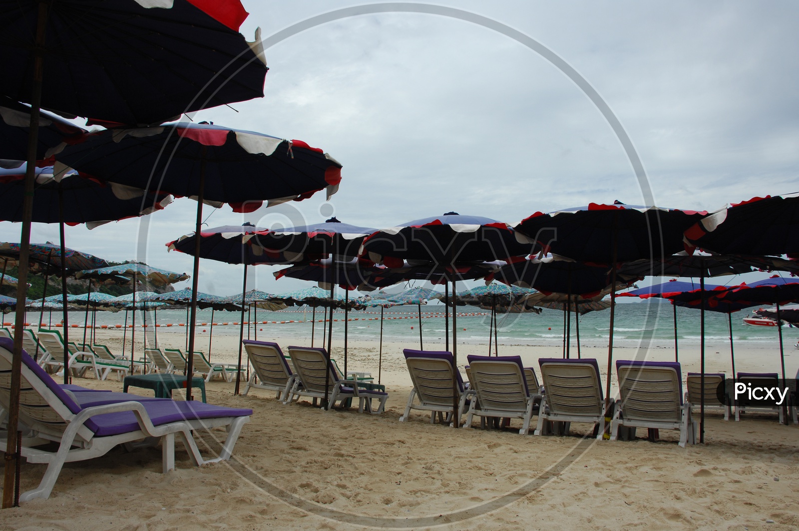Pool chairs with umbrellas at the beach