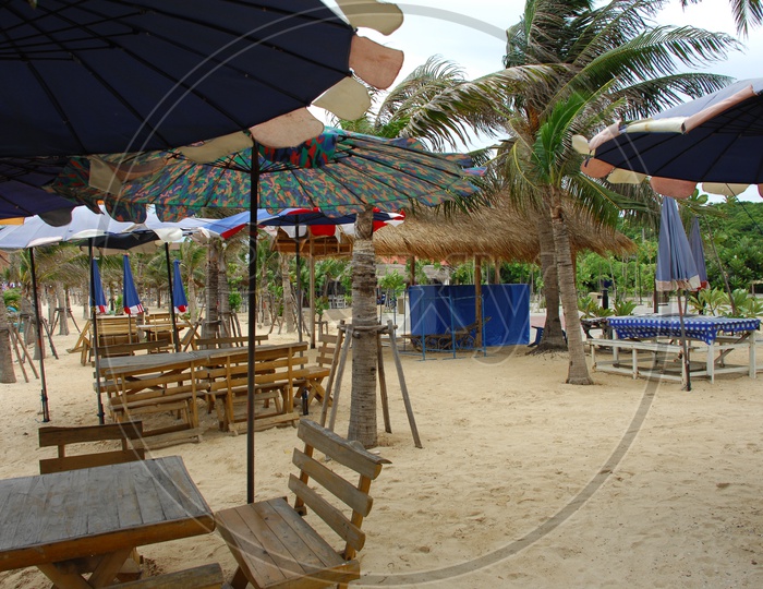 Wooden Tables and chairs along the beach shore