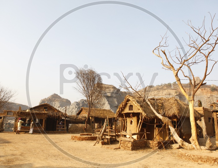 Thatched mud huts and road in a village