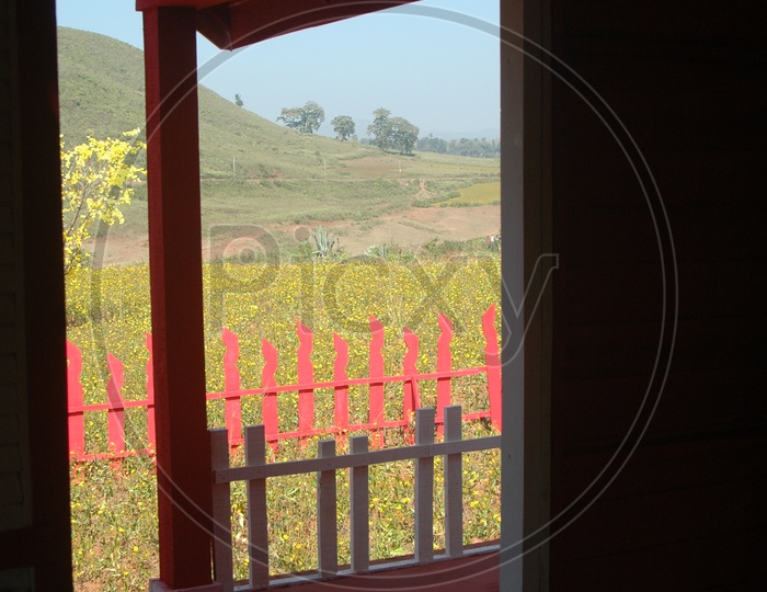 View of the fields in Araku valley through a door