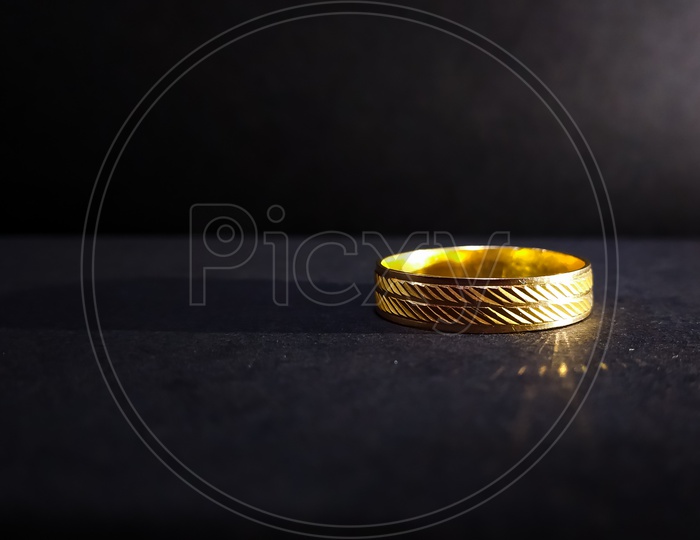 Gold finger ring with black background