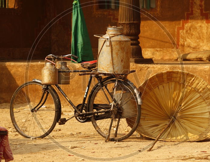 Milk Cans Tied on  Bicycle in Village