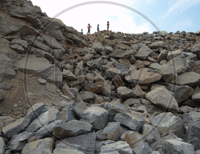 Three Men standing on top of the Granite boulder quarry