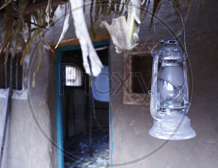 Lantern in front of a mud house