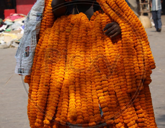 A Vendor Carrying Marigold Flower Garlands