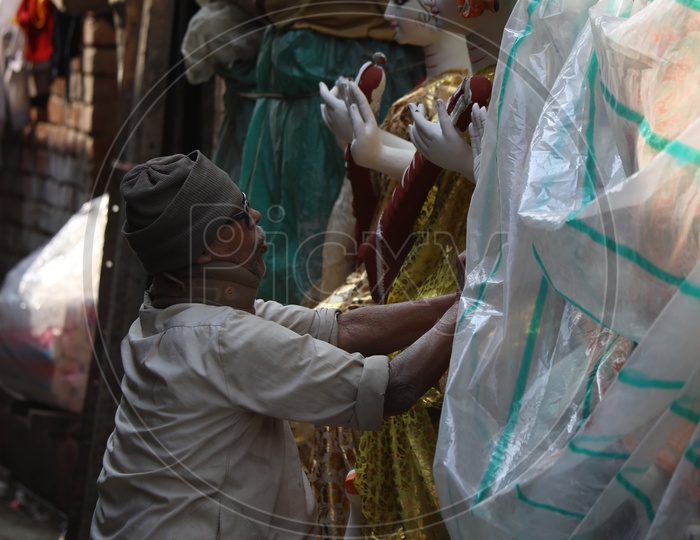 An Artist Giving the Final Detailing  for Durga Idols