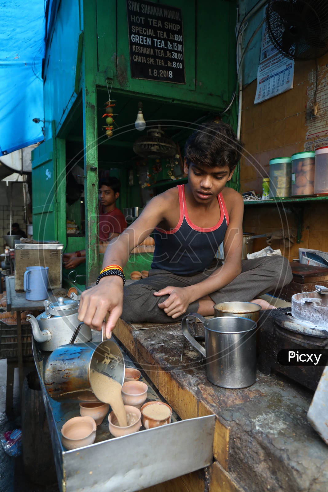Indian Young Boy at a Tea Vendor Stall