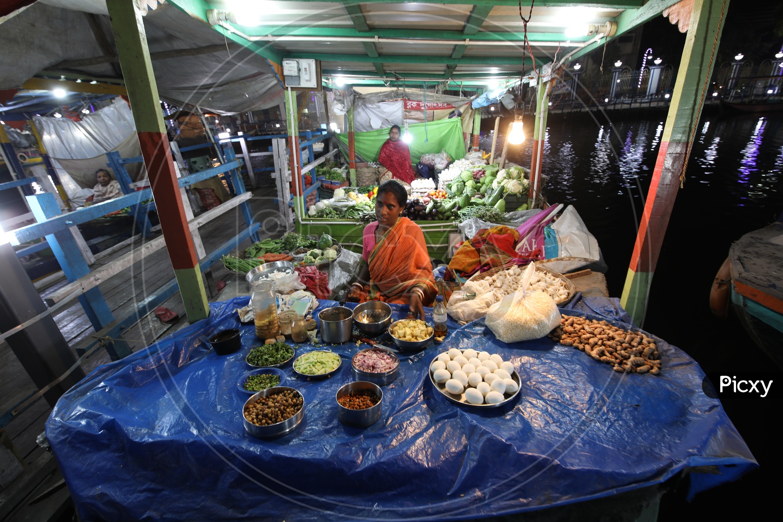 A Woman Street Food Vendor In a Stall At The Floating Market
