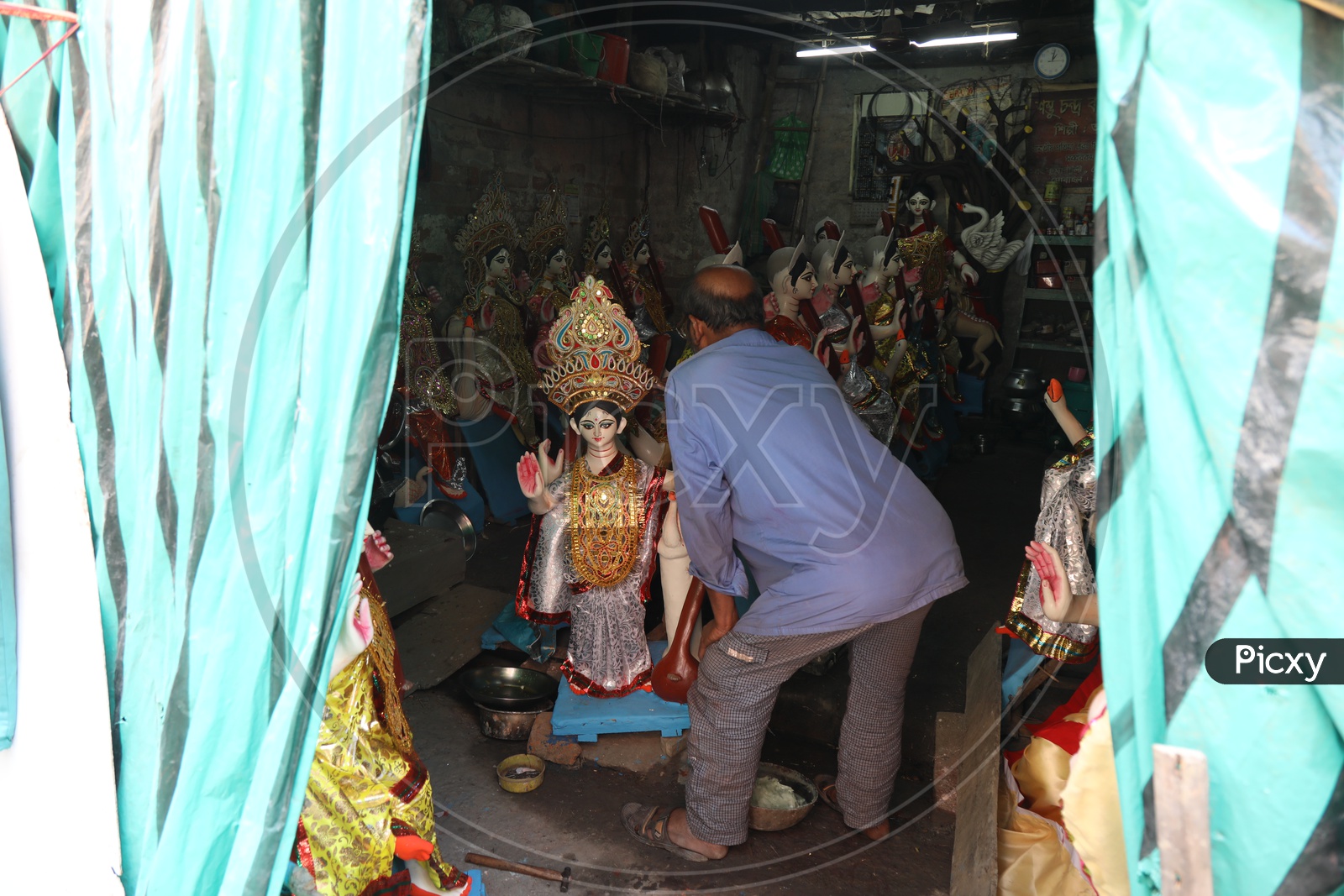 An Artist Giving Final Detailing For Goddess Durga Idols