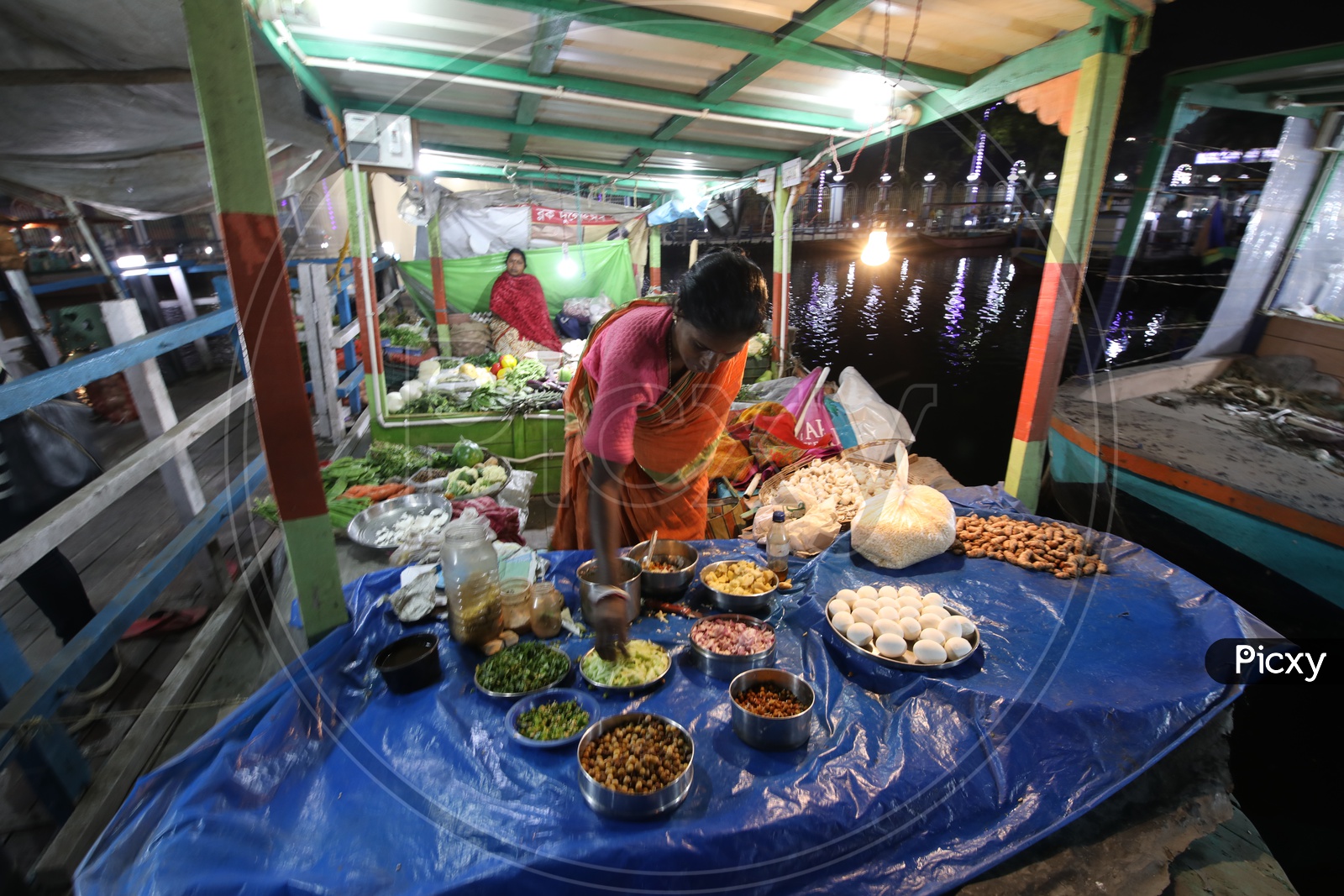 A Woman Street Food Vendor In a Stall At The Floating Market