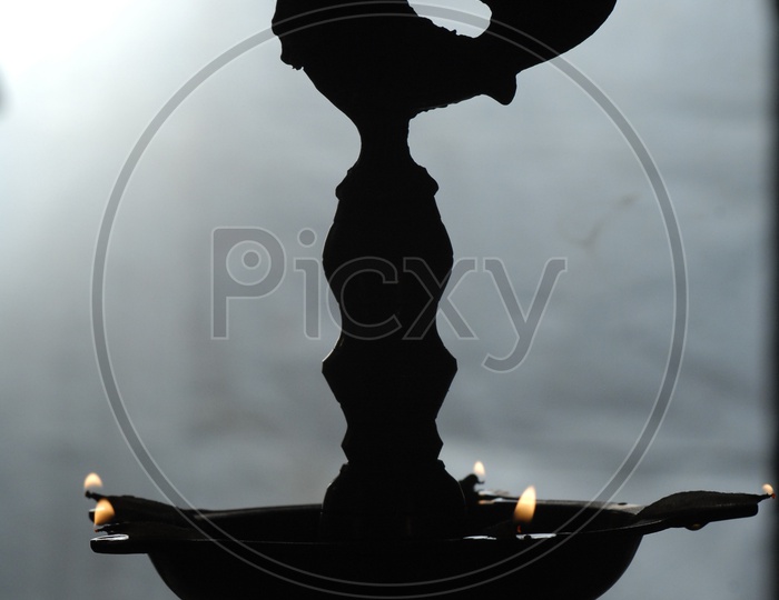 Silhouette of an oil lamp diya
