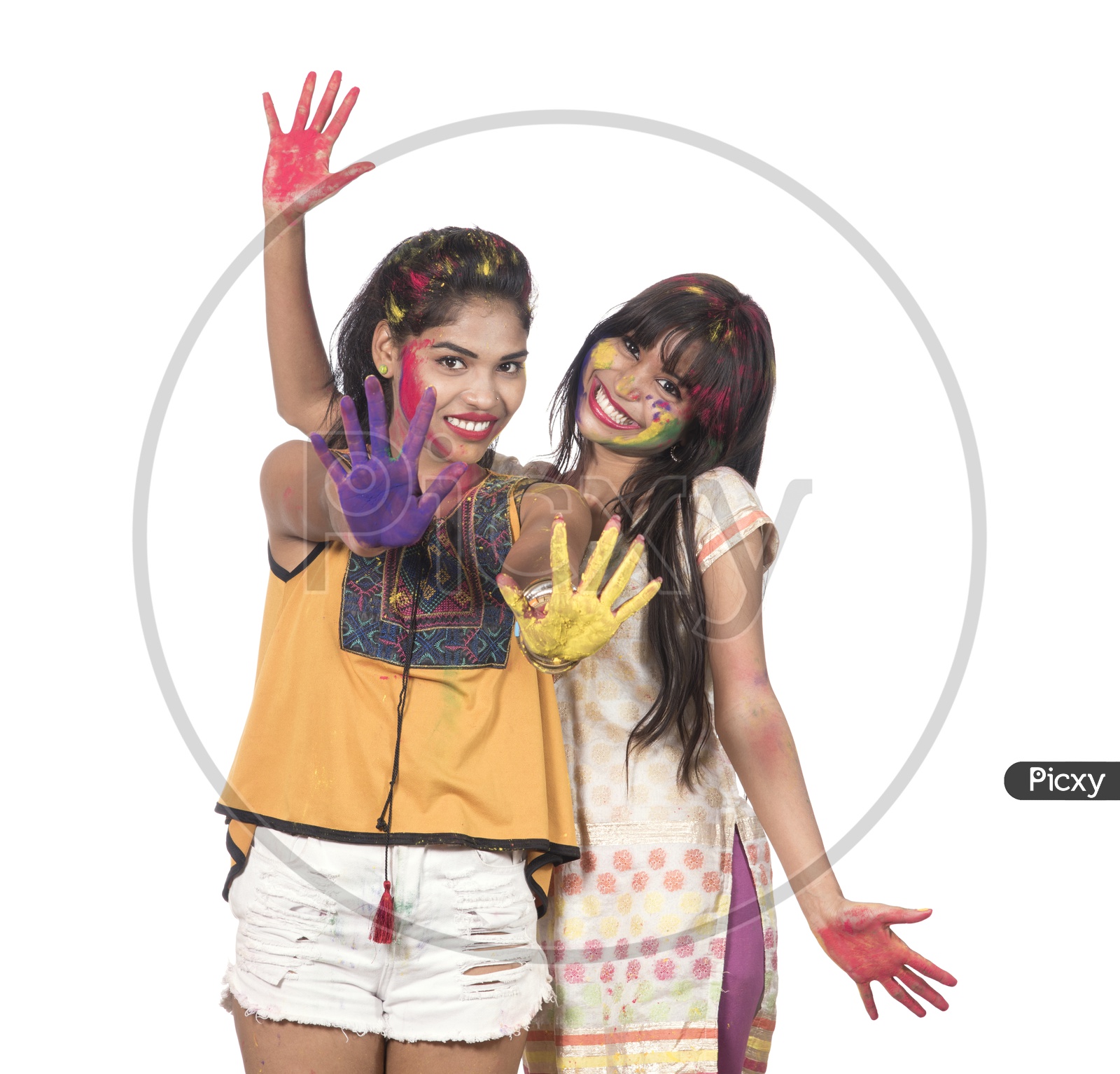 Happily Smiling Young Indian Girls Celebrating  With Colours