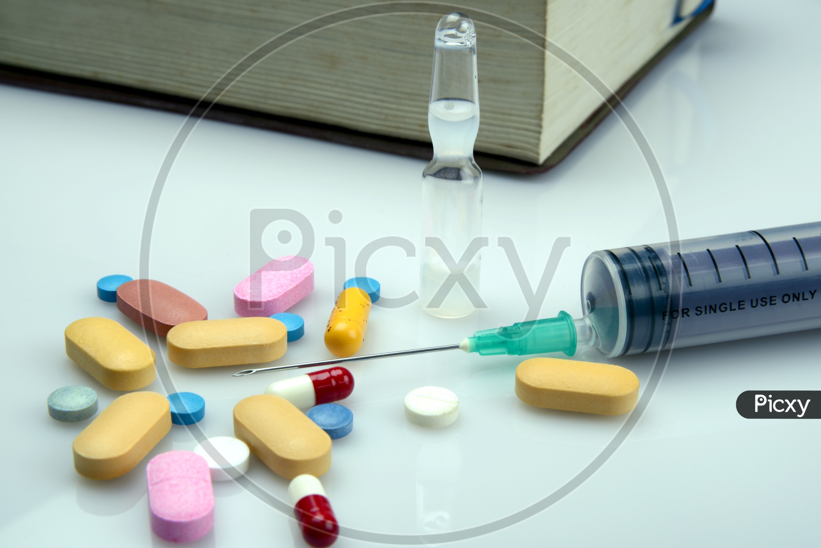 Various Painkiller pills and syringe on white background