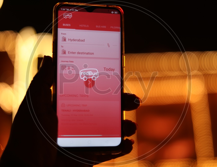 Indian Man Using Red Bus App In Smartphone For Bus Ticket Booking