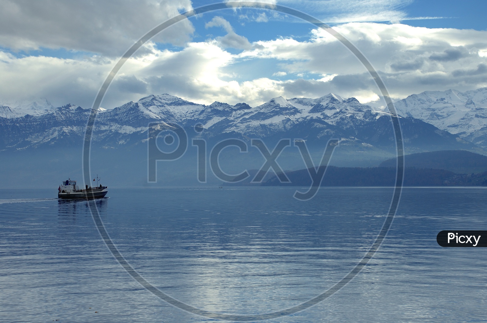 Beautiful swiss alps with boat sailing in the foreground