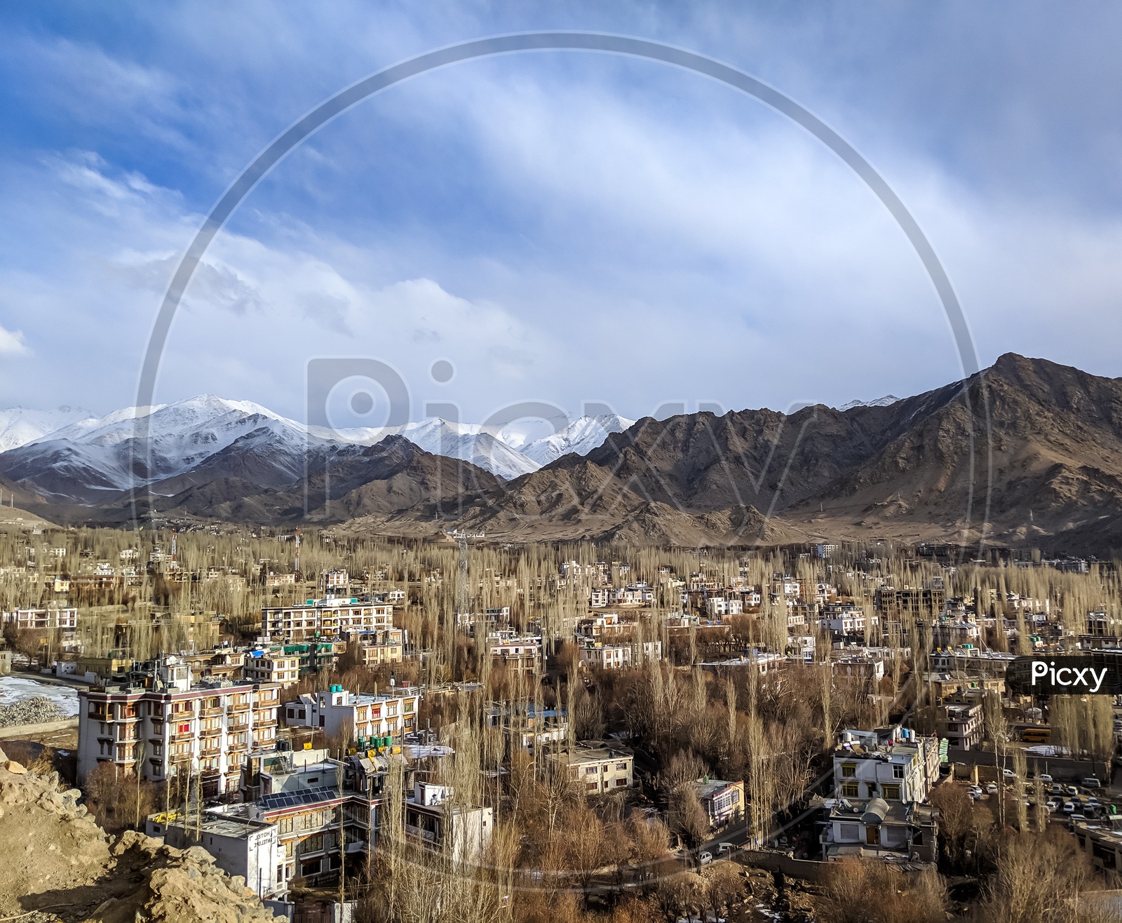 Aerial View Of Houses in Villages Leh With Snow Capped Mountains In Background