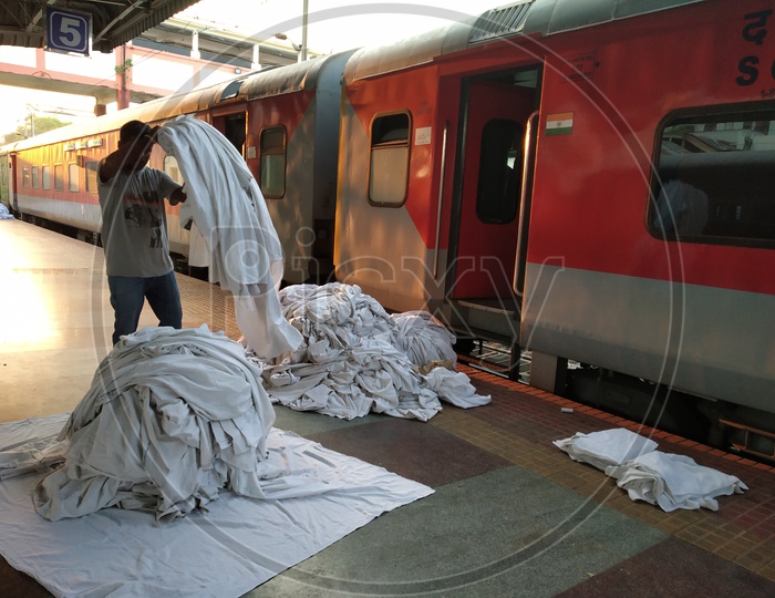 Image of House keeping Workers Collecting The Bed Sheets From AC