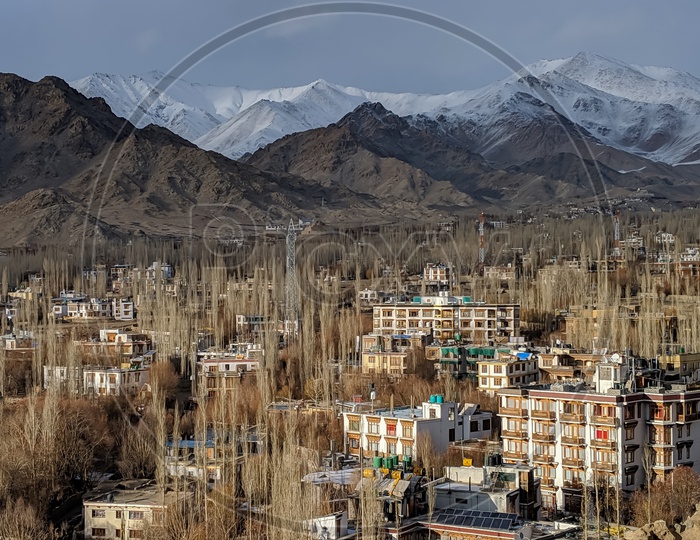 Aerial View Of Houses in Villages Leh With Snow Capped Mountains In Background