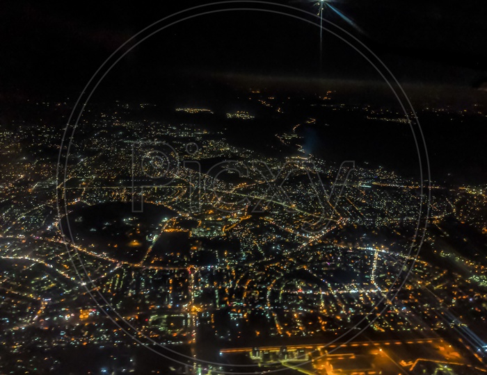 Aerial View Of A City Night Lights From Flight Window