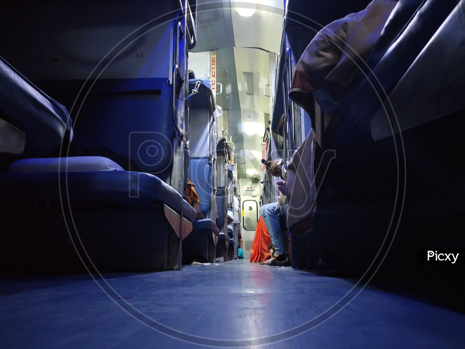 A View Of Pathways In Railway Compartment Bogies With Berths And Passengers  in Indian trains