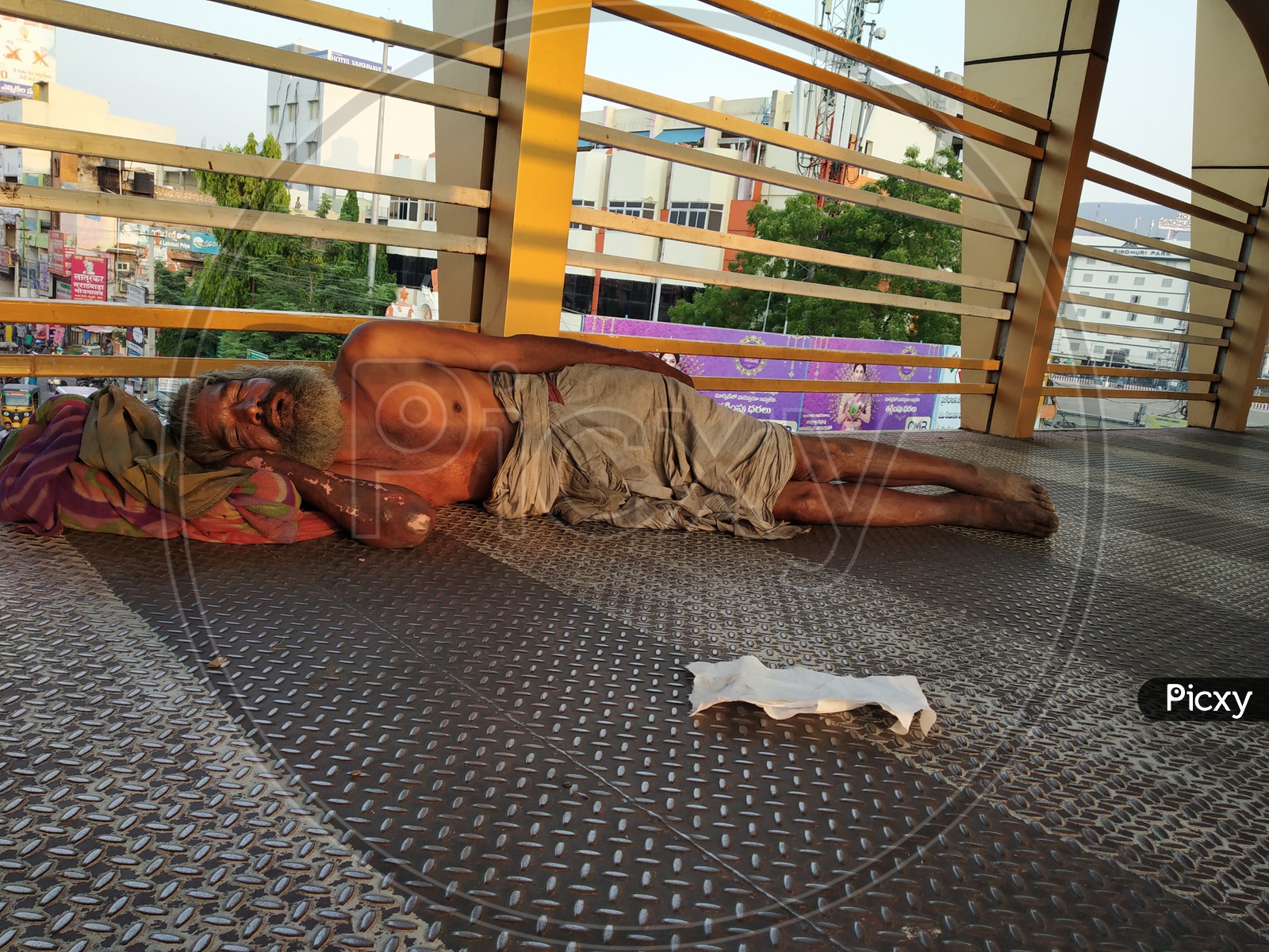 Indian beggar sleeping on the floor