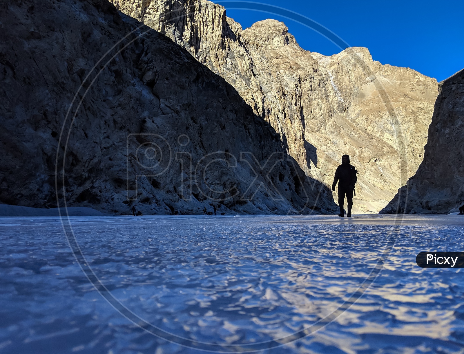 Silhouette of an Adventurer Or Man Walking On The Frozen Ice of River Zanskar  Valley