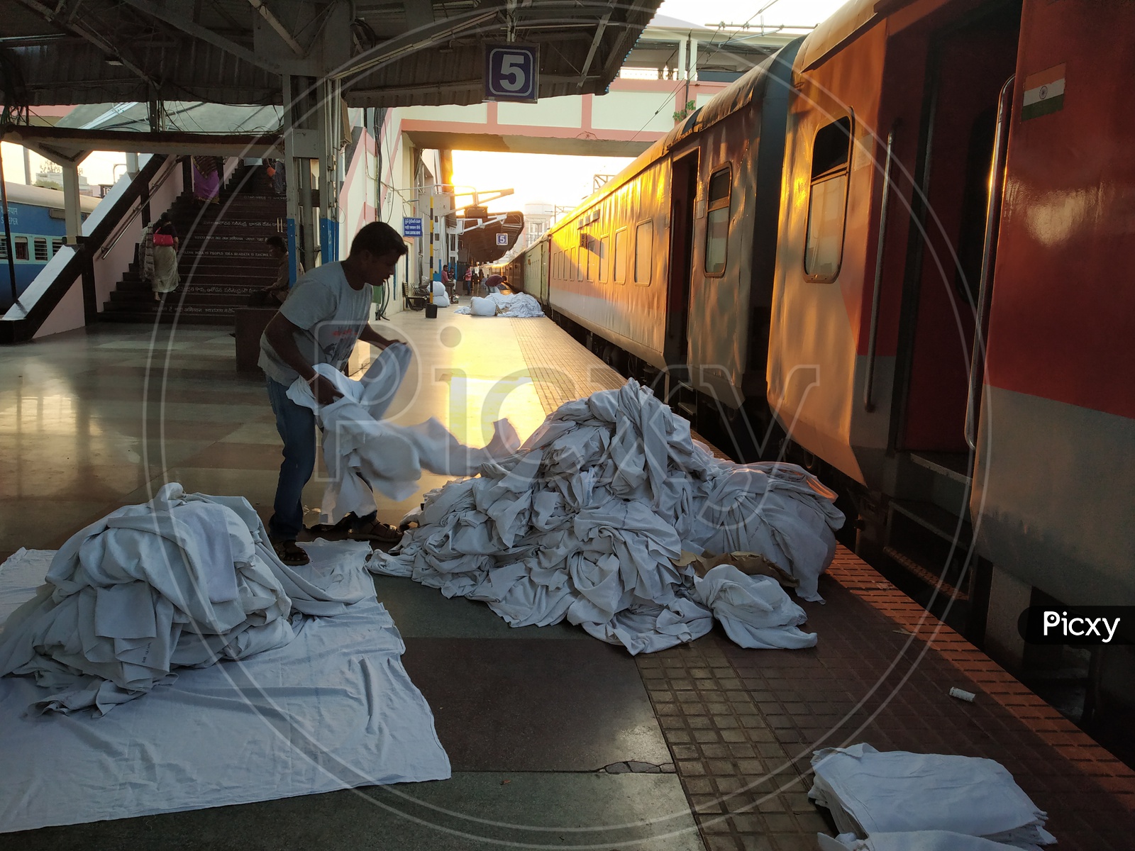 Image of House keeping Workers Collecting The Bed Sheets From AC