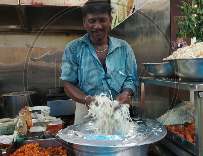Fast Food Vendor preparing the Noodles