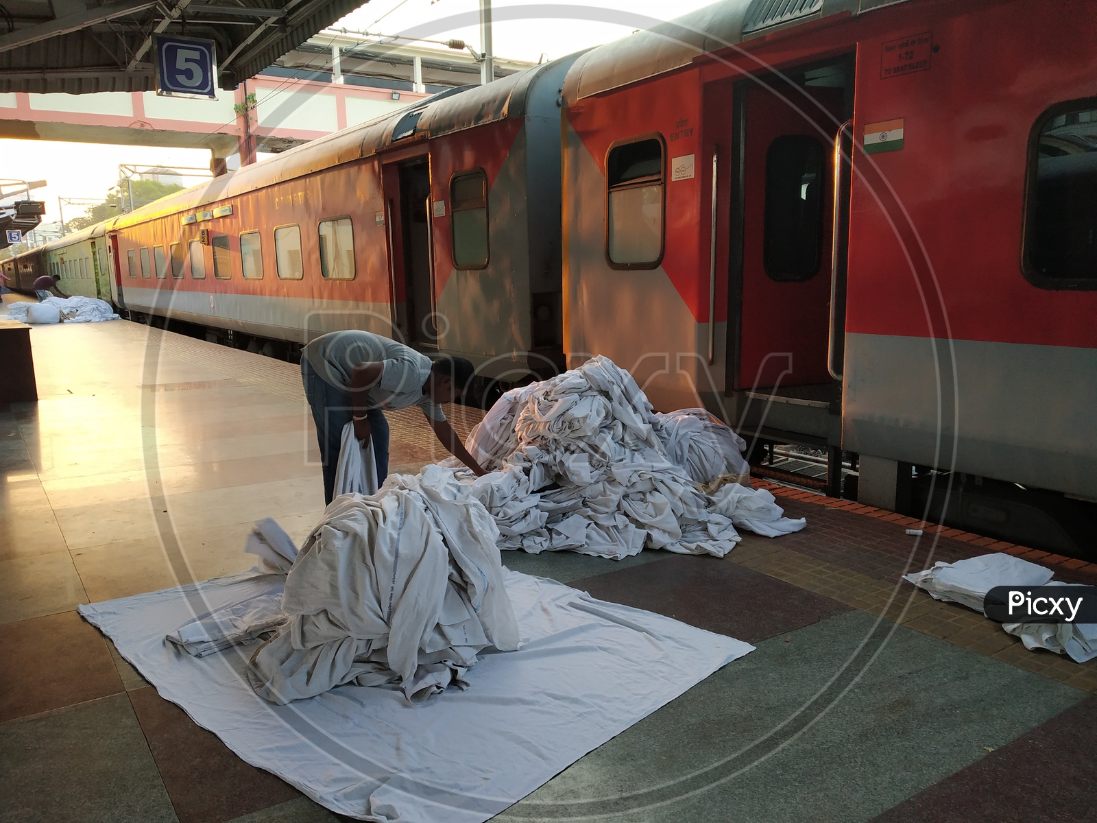 Image of House keeping Workers Collecting The Bed Sheets From AC