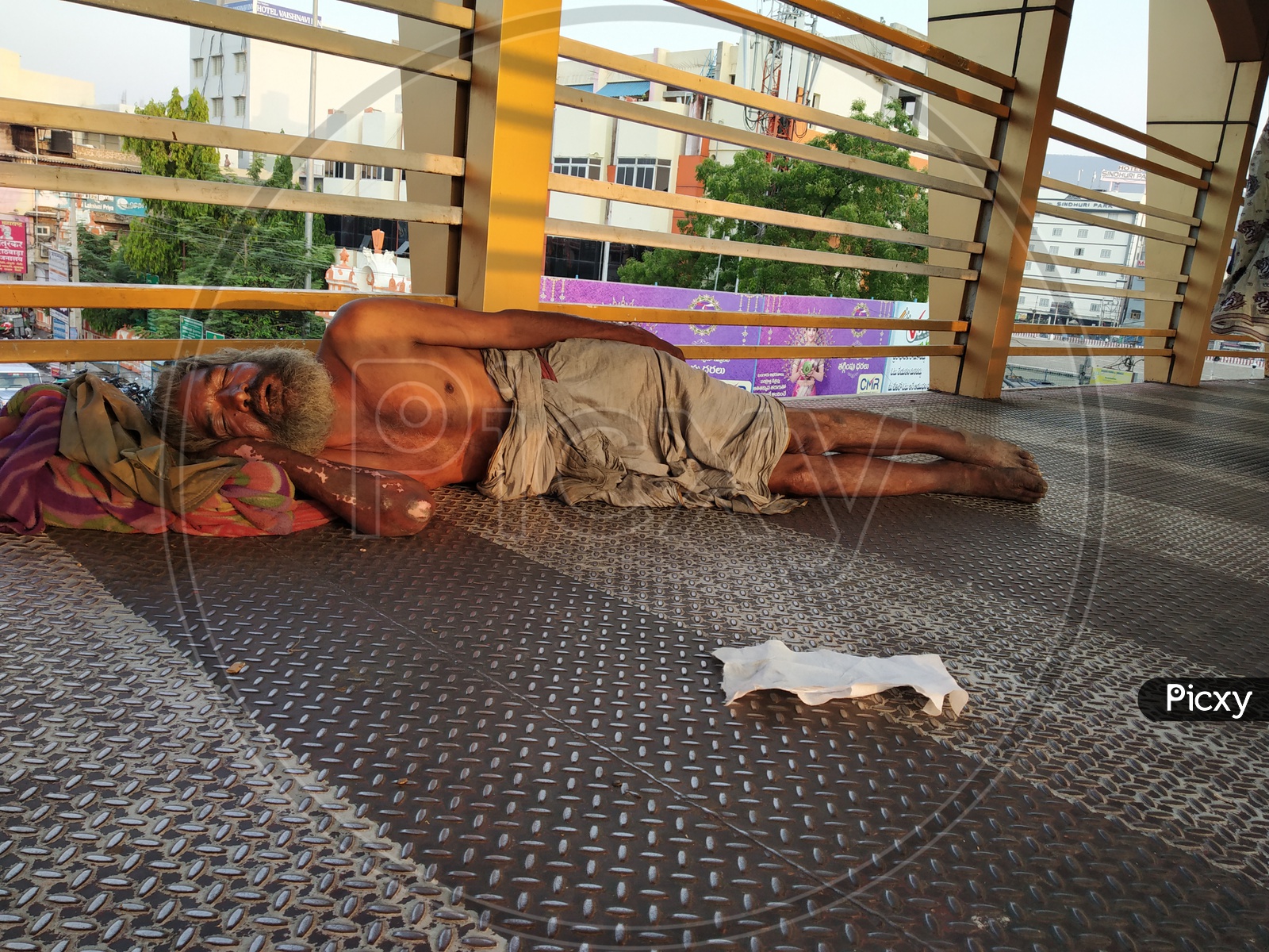 Indian beggar sleeping on the floor