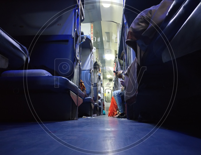 A View Of Pathways In Railway Compartment Bogies With Berths And Passengers  in Indian trains