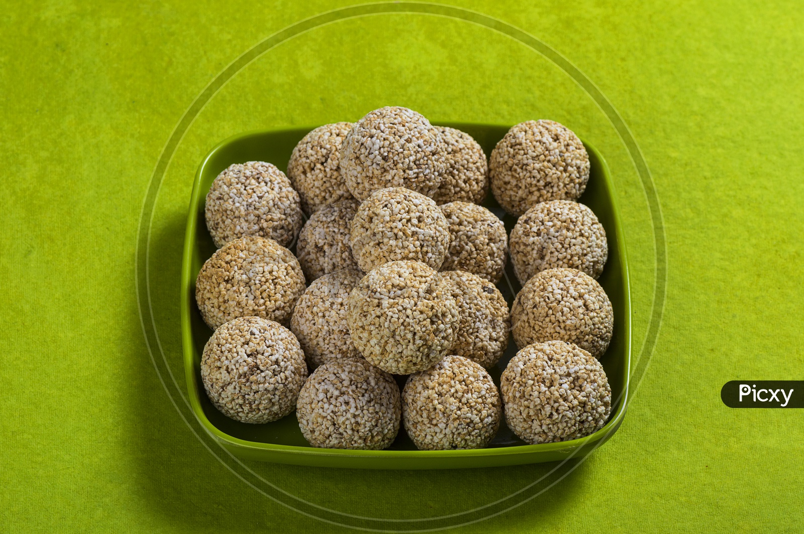 Amaranth or Rajgira laddu in a green square plate on green background