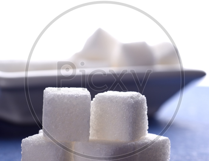 Sugar cubes on blue and white background