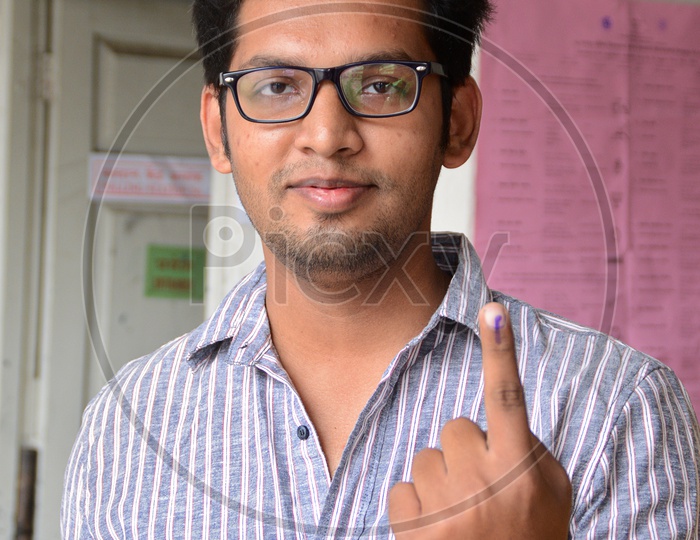 people show their ink-marked fingers after casting their votes