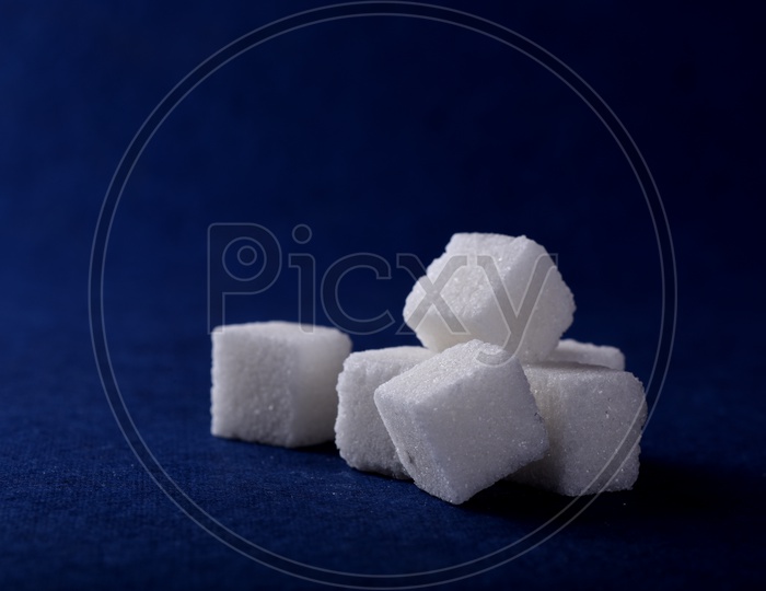 Image of Sugar cubes on blue background-LD257794-Picxy