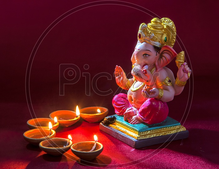 Lord Ganesh Idol with lightened up diya's